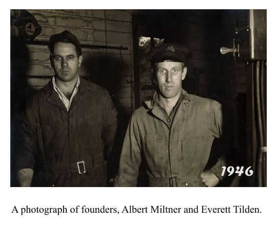 Photograph of Albert Miltner and Everett Tilden inside Station Garage. 